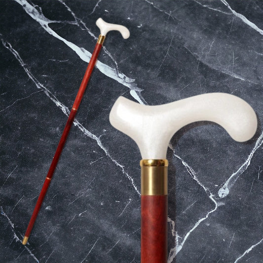 a red and white cane sitting on top of a marble counter